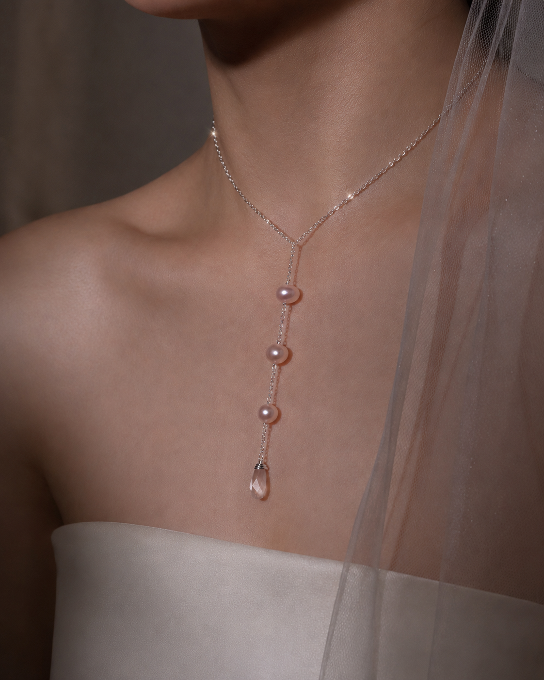 Necklace with pink gemstones worn by a person, blurred background