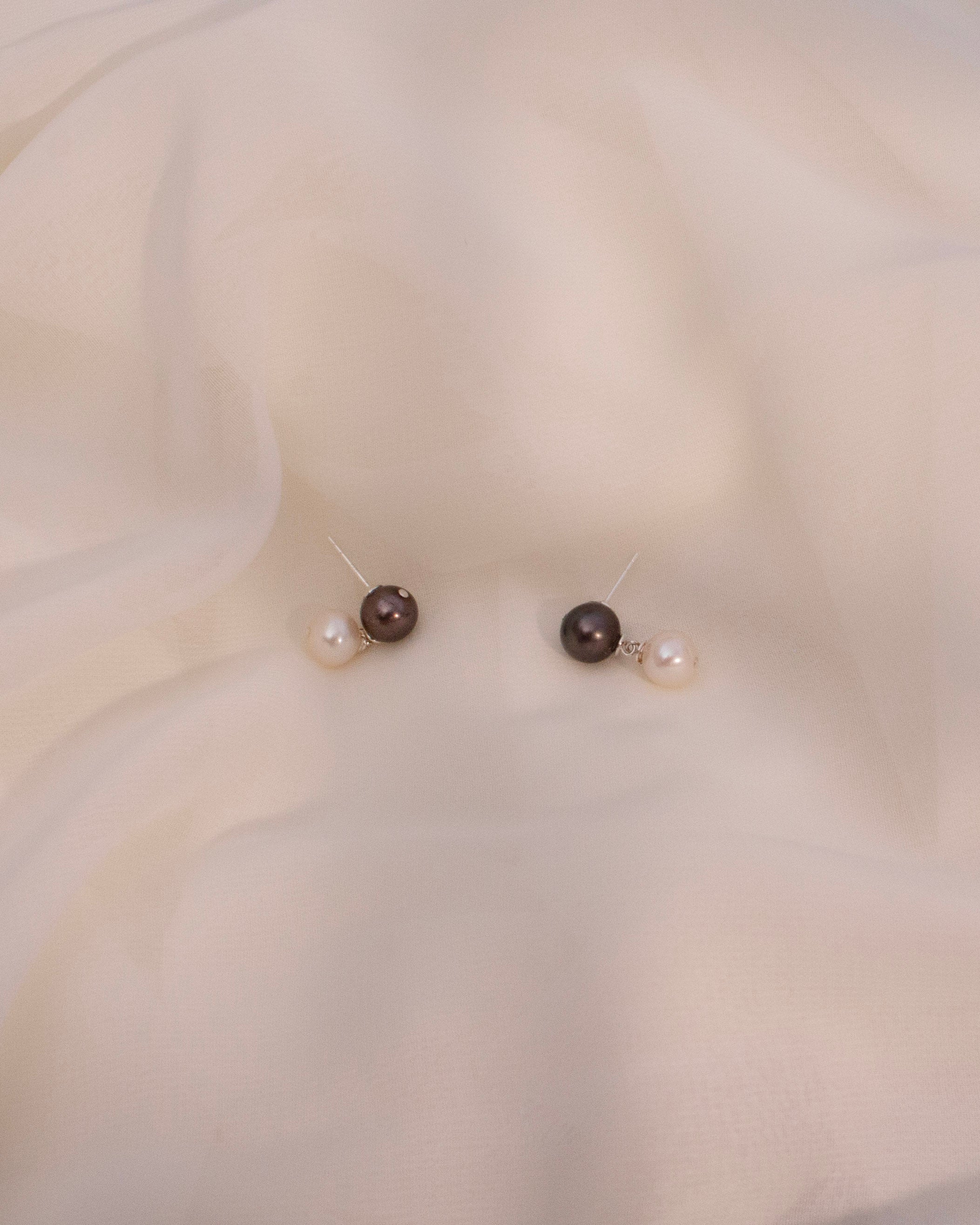 Pearl necklace on a white fabric background