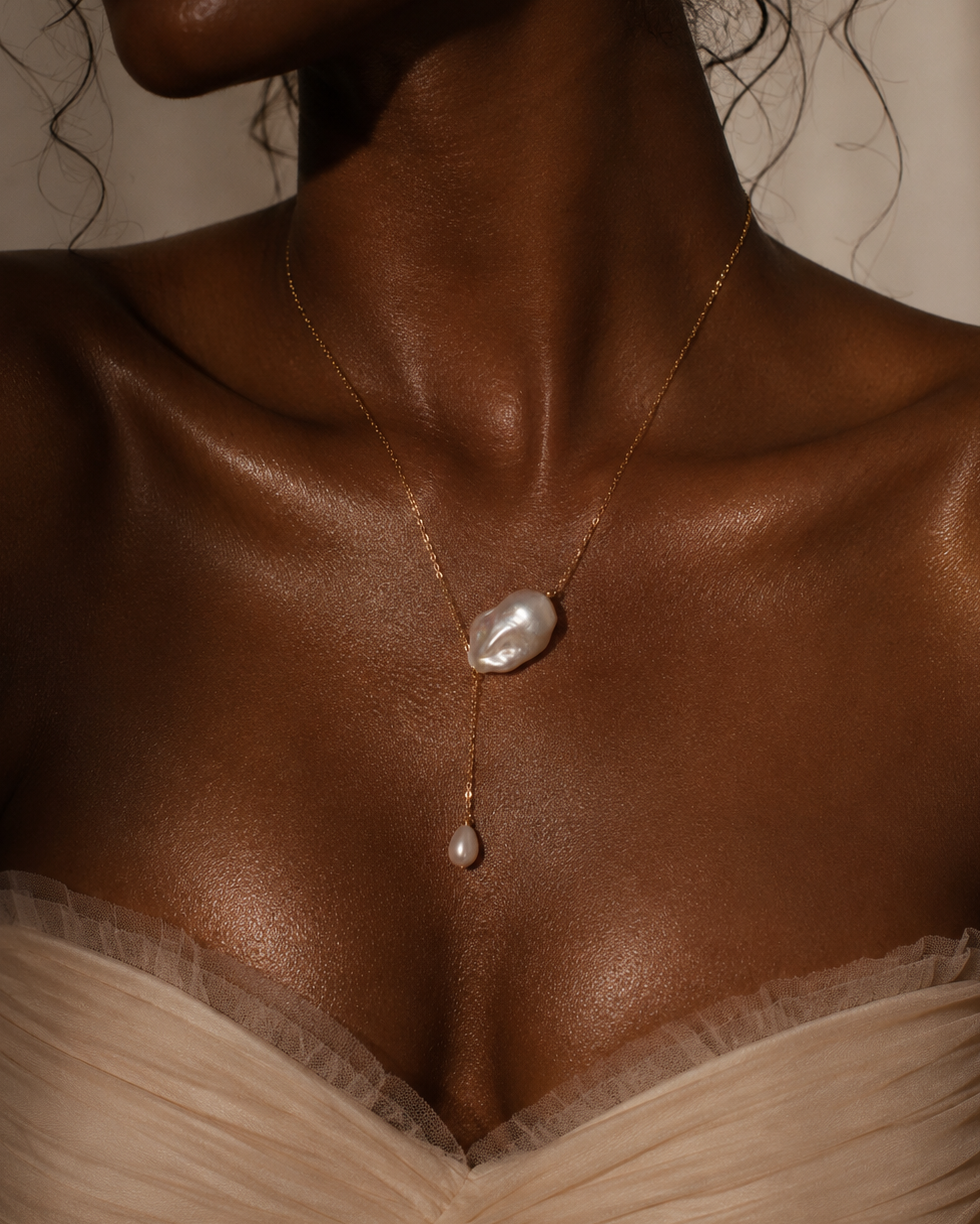 Pearl necklace on a model with a neutral background