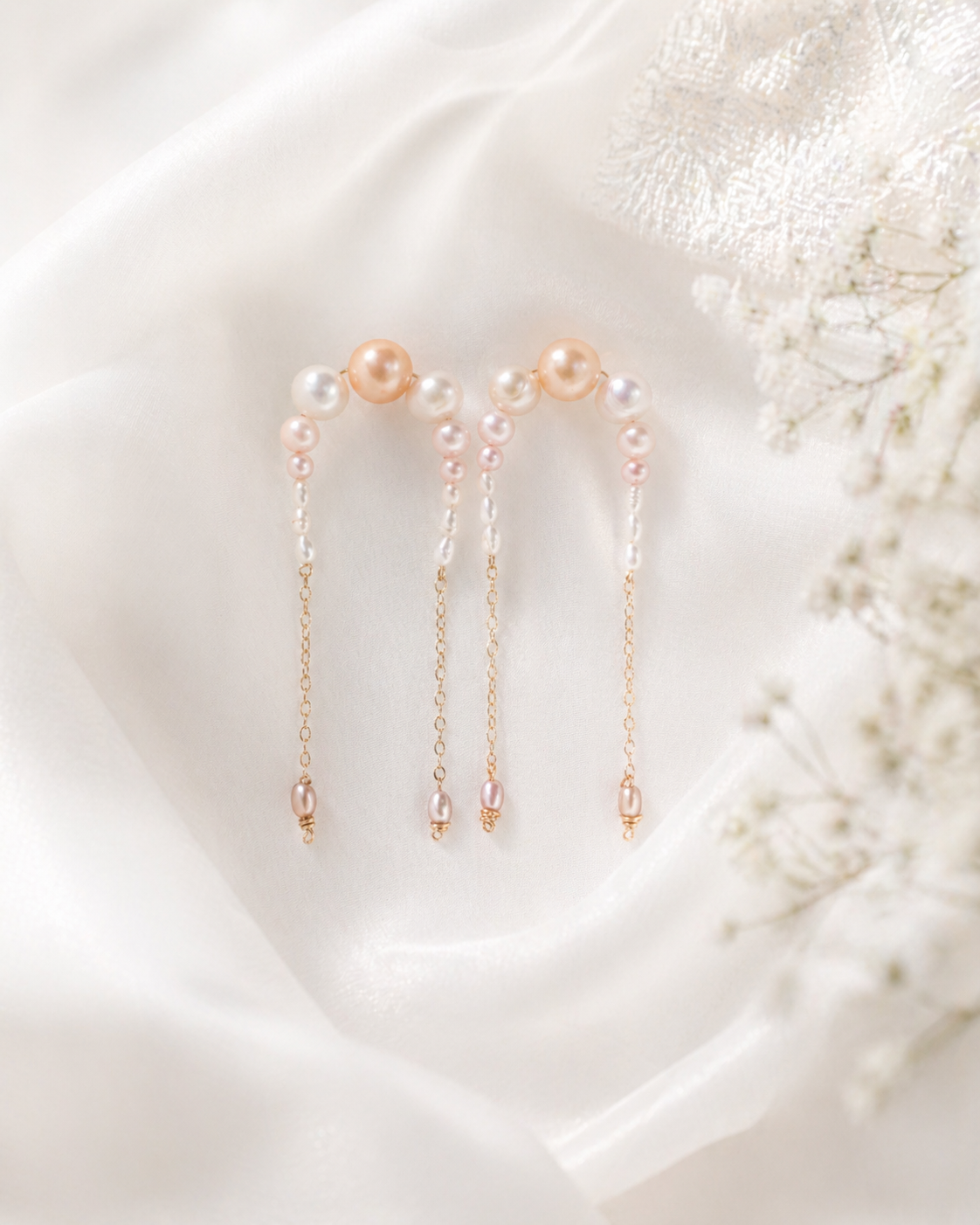Pair of pearl earrings on a soft white background